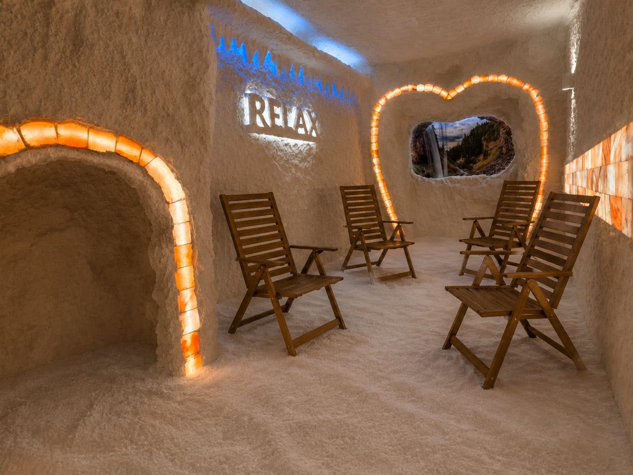 A salt room with wooden chairs, a salt archway and decorative lighting