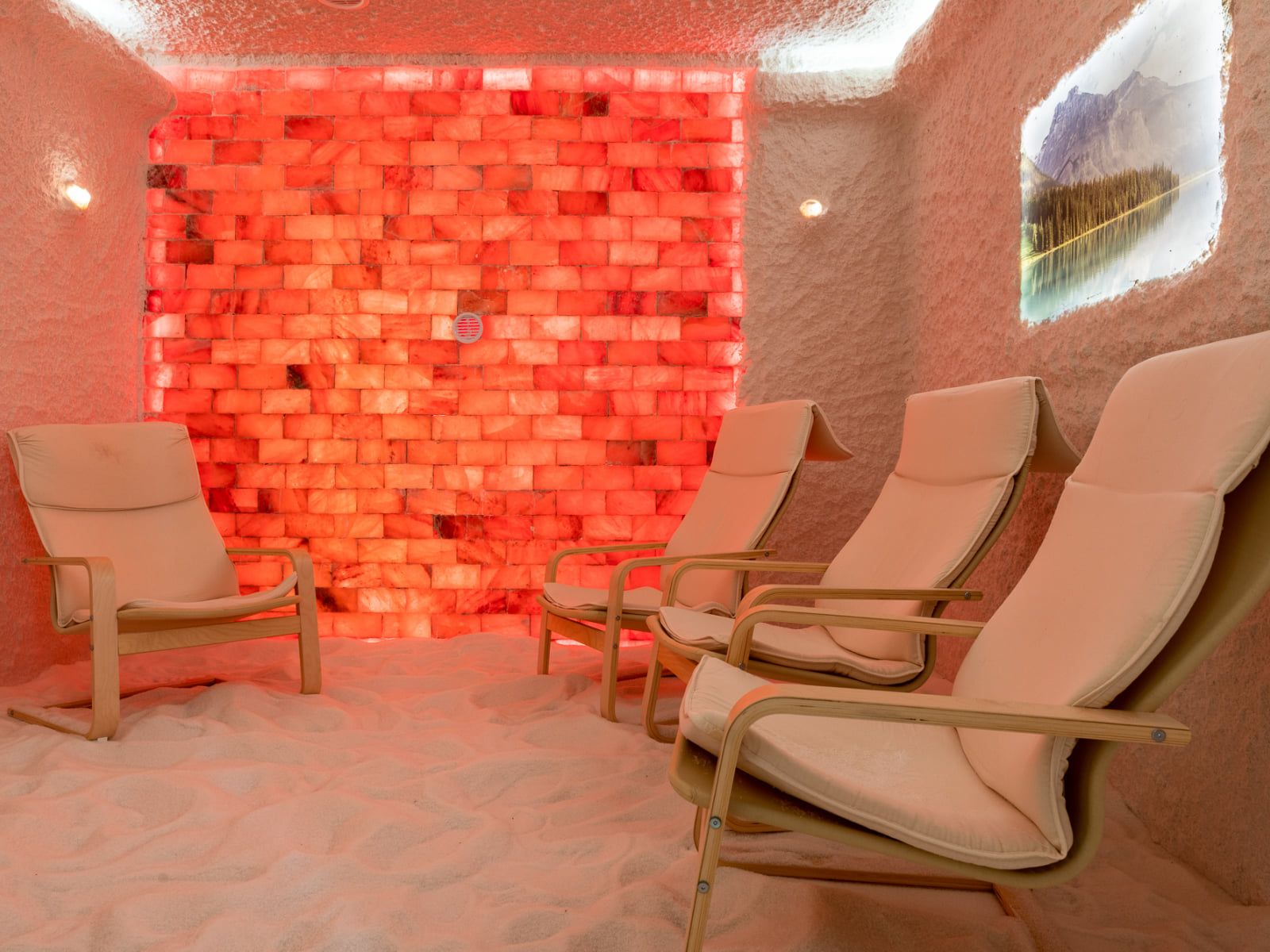 A bright salt room with loungers and a children’s play corner